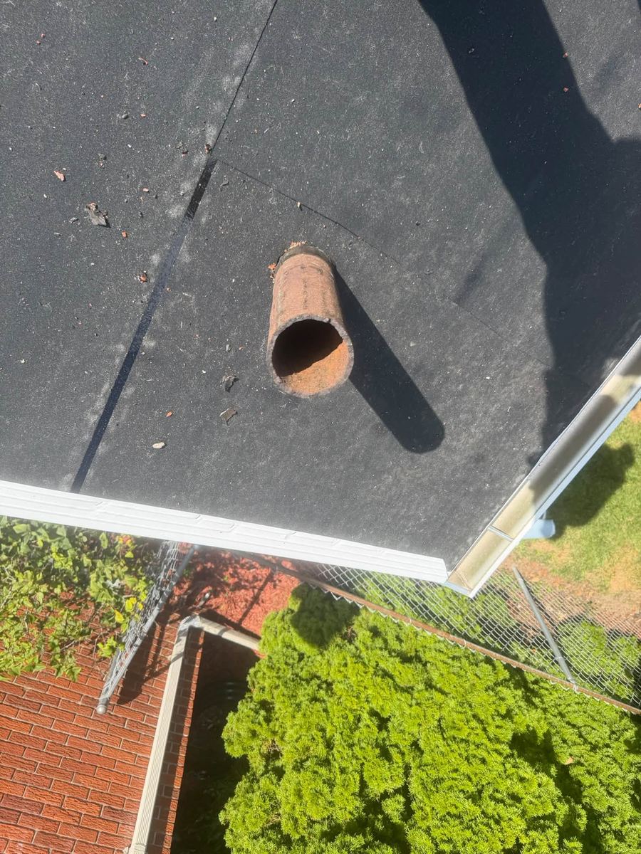 A new pipe boot fitted over a plumbing vent pipe on fresh underlayment